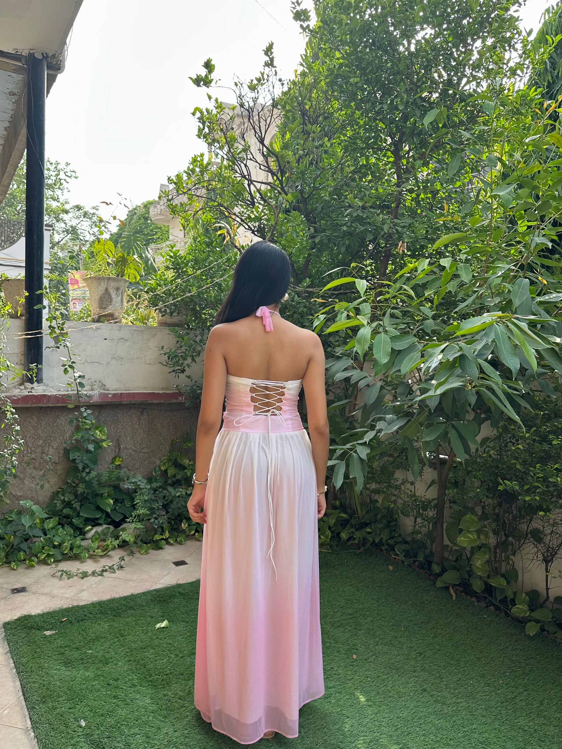 Elegant pink and white ombre maxi dress for women featuring a ruched halter neckline, cut-out bodice, empire waist, and flowy mesh skirt. This feminine summer dress is perfect for vacations, brunch dates, beach holidays, birthday celebrations, resort wear, and special occasions.