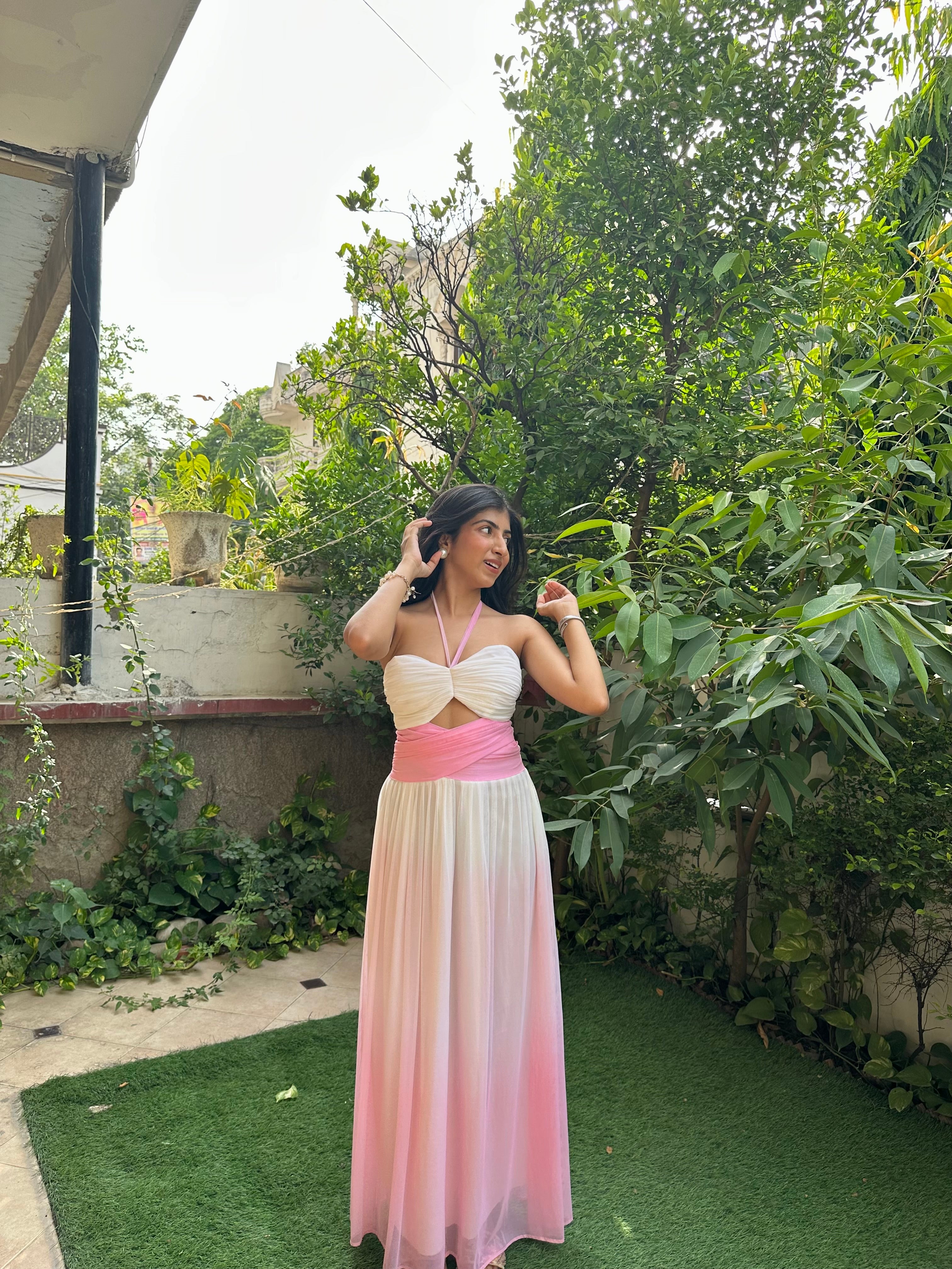 Elegant pink and white ombre maxi dress for women featuring a ruched halter neckline, cut-out bodice, empire waist, and flowy mesh skirt. This feminine summer dress is perfect for vacations, brunch dates, beach holidays, birthday celebrations, resort wear, and special occasions.