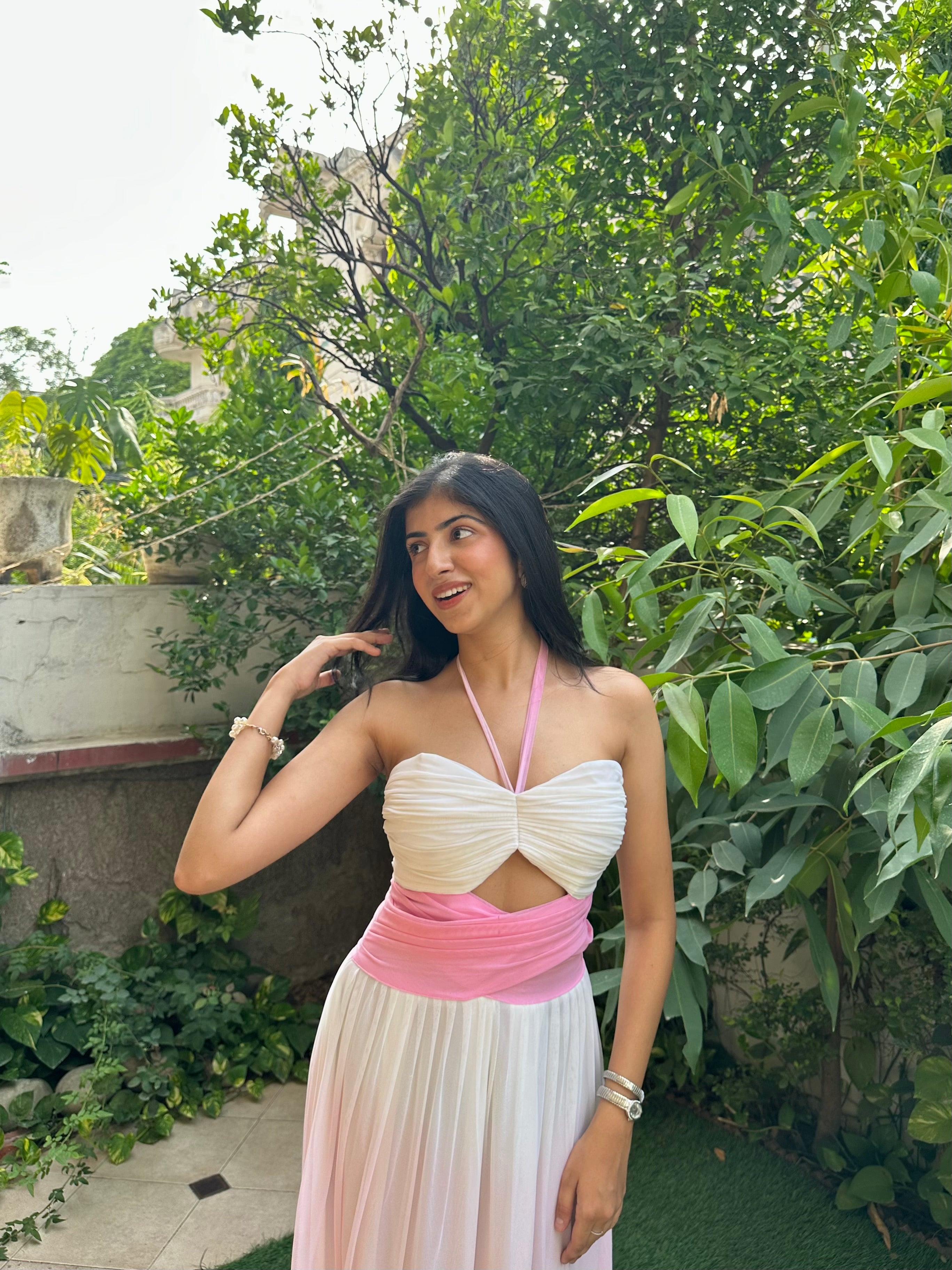 Elegant pink and white ombre maxi dress for women featuring a ruched halter neckline, cut-out bodice, empire waist, and flowy mesh skirt. This feminine summer dress is perfect for vacations, brunch dates, beach holidays, birthday celebrations, resort wear, and special occasions.