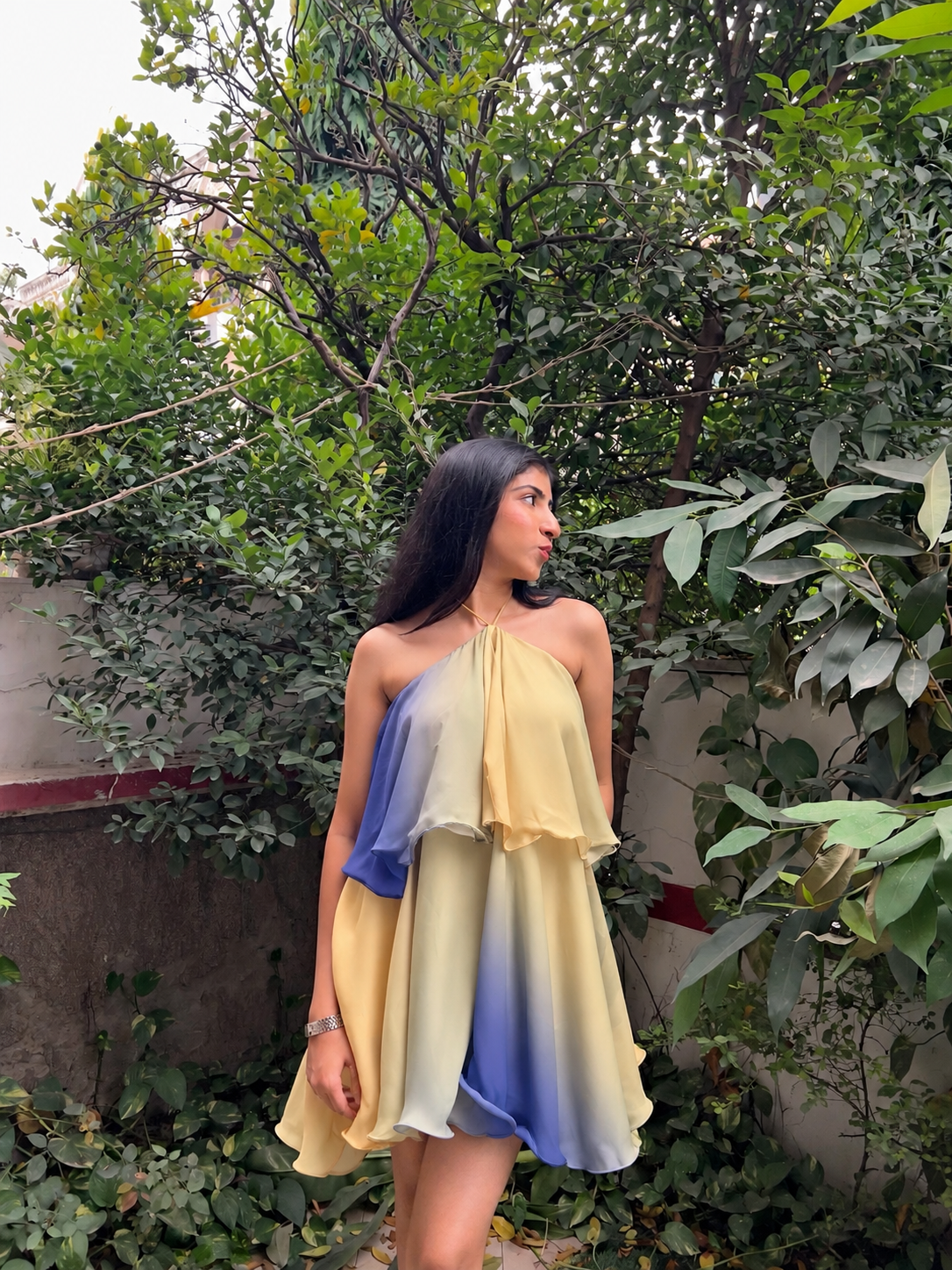 Sunset Sorbet Pastel Ombre Mini Dress by Tres Clothing is a dreamy halter neck mini dress featuring a beautiful blend of butter yellow, soft peach, powder blue, and pastel hues. Designed with a flowy silhouette and layered ruffle detailing, this flattering summer dress is perfect for women who love trendy, feminine, and statement-making outfits. Whether you’re looking for a pastel ombre dress, a stylish ruffle mini dress, a halter neck dress for women, or a cute summer party wear outfit, Sunset Sorbet is pe