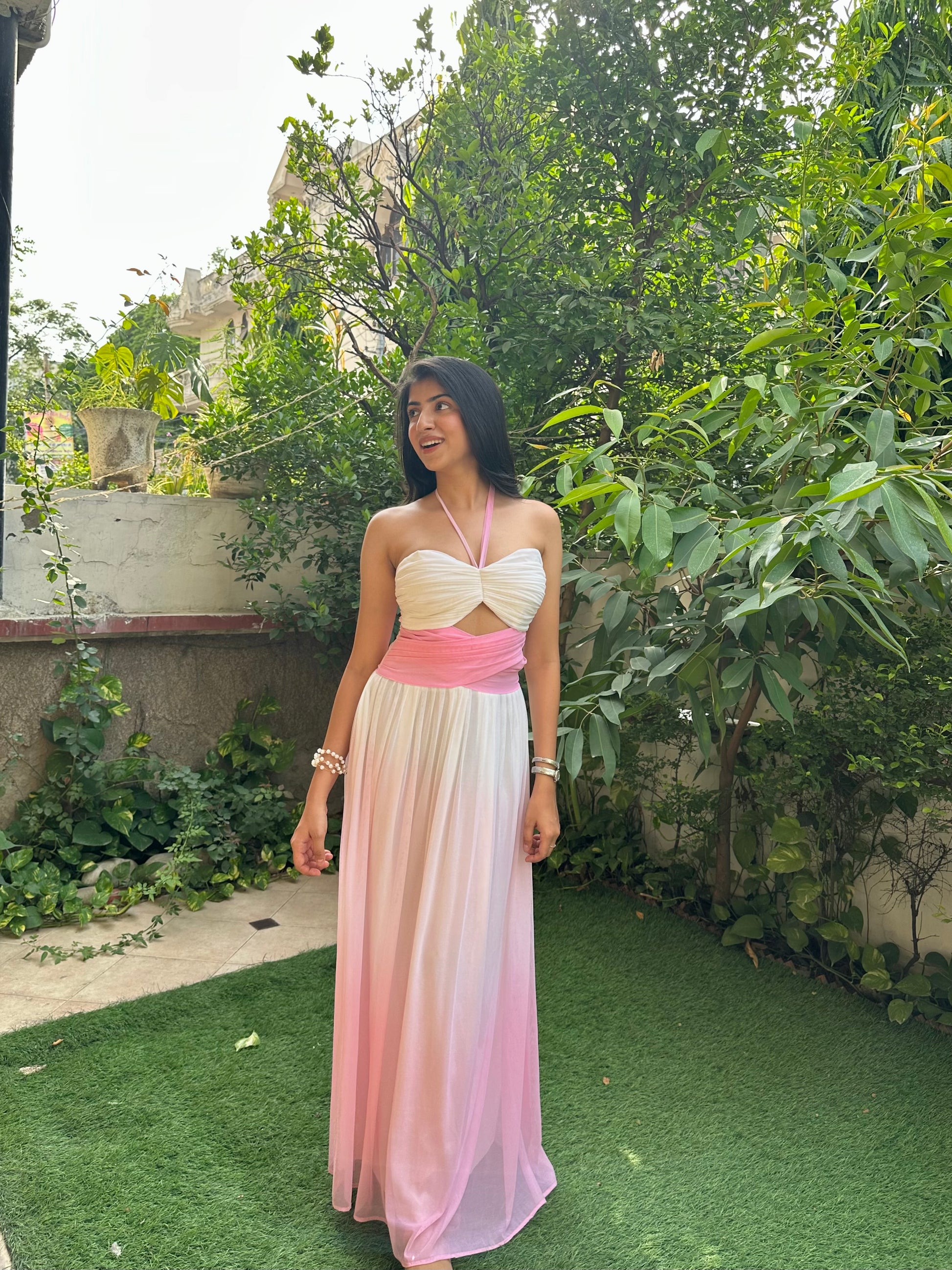 Elegant pink and white ombre maxi dress for women featuring a ruched halter neckline, cut-out bodice, empire waist, and flowy mesh skirt. This feminine summer dress is perfect for vacations, brunch dates, beach holidays, birthday celebrations, resort wear, and special occasions.